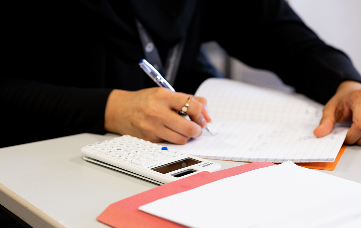 Student writing in a notebook