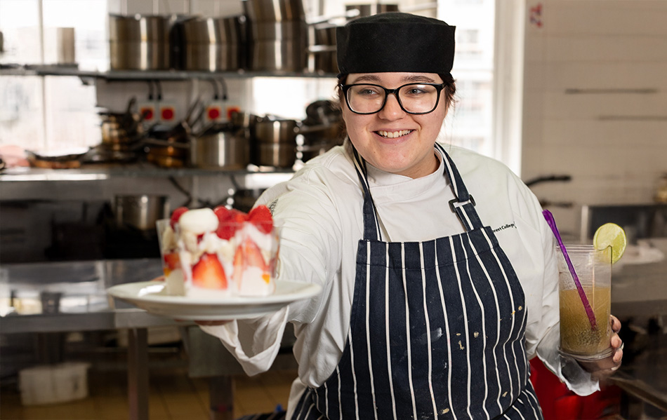 Catering student presenting a strawberry dessert