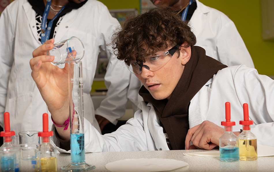 Science student mixing chemicals in a lab