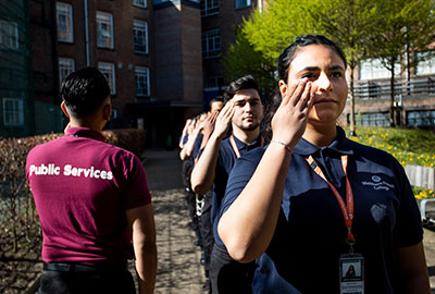 Public services students saluting in a line up