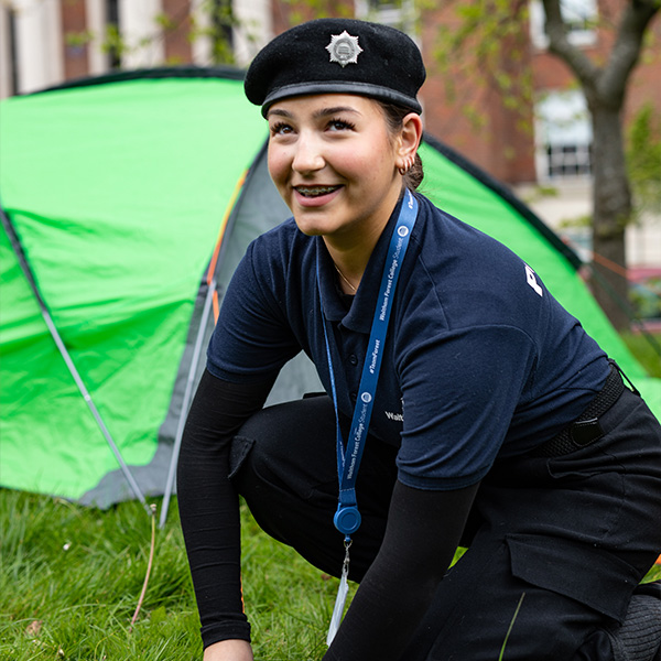 Public service student setting up a tent